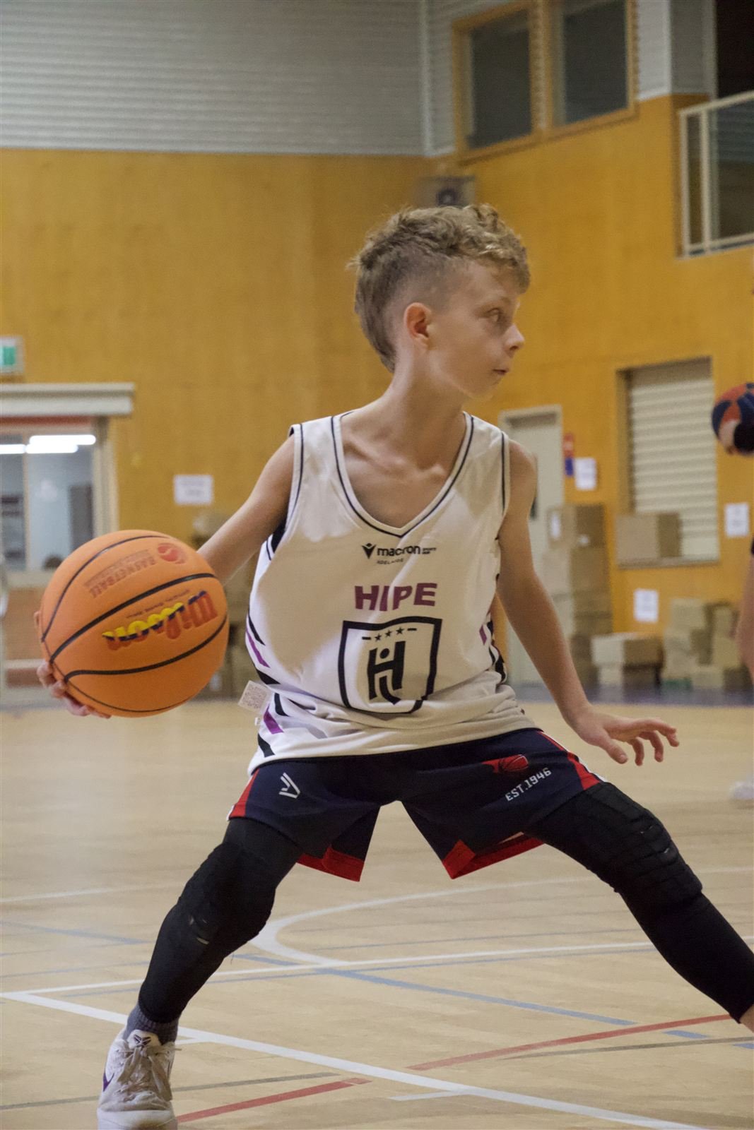 Junior player in a HIPE singlet working on ball handling