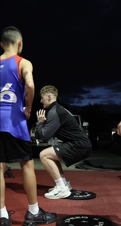 Coach assessing an athlete during a performance session
